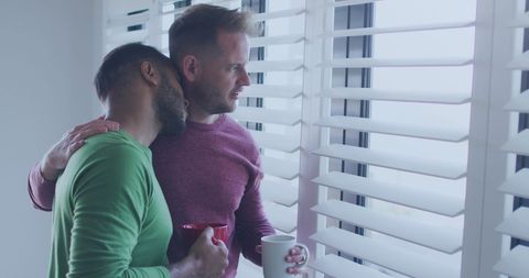 Loving Gay Couple Embracing by Window with Coffee Mugs - Download Free Stock Images Pikwizard.com