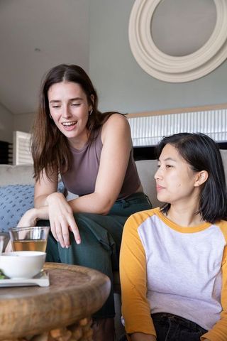Diverse Friends Chatting and Drinking Tea in Cozy Living Room