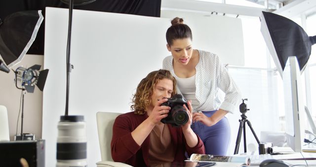 Photographer and Assistant Reviewing Images - Download Free Stock Images Pikwizard.com