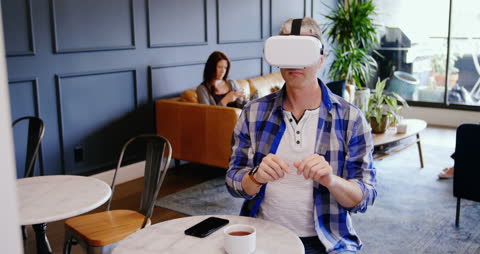 Business Professional Engaging with VR Technology in Modern Office Lobby