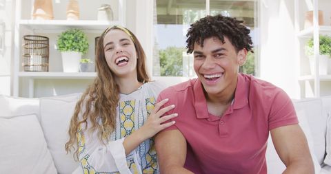 Cheerful Biracial Couple Enjoying Leisure Time at Home