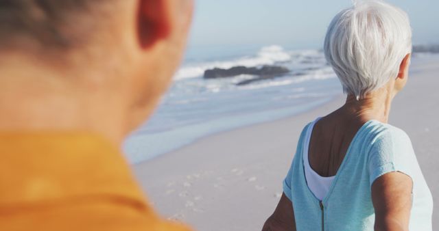 Elderly Couple Enjoying Peaceful Walk on Beach - Download Free Stock Images Pikwizard.com