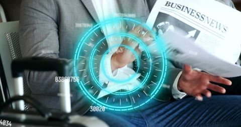 Business traveler reading newspaper, gesturing with futuristic hud overlay at airport gate