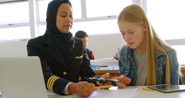 Female Pilot Teaching Student About Drone Technology in Classroom - Download Free Stock Images Pikwizard.com