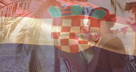 Couple sharing kiss on tropical beach with croatian flag overlay