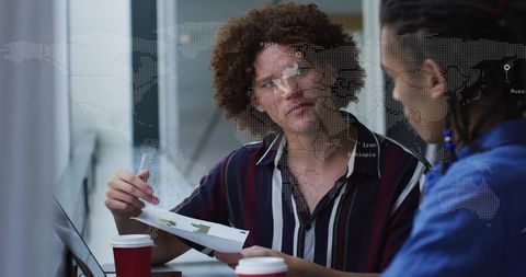 Business team discussing global sales report, laptop and coffee, analyzing charts and maps