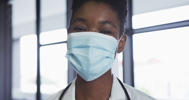 Healthcare Professional Wearing Protective Face Mask Smiling at Work - Download Free Stock Images Pikwizard.com