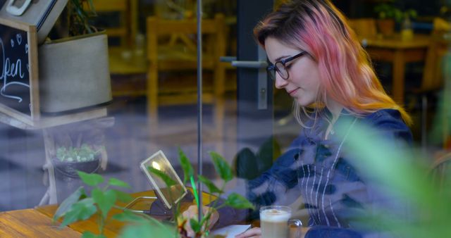 Young Woman Working on Her Tablet in Stylish Cafe - Download Free Stock Images Pikwizard.com