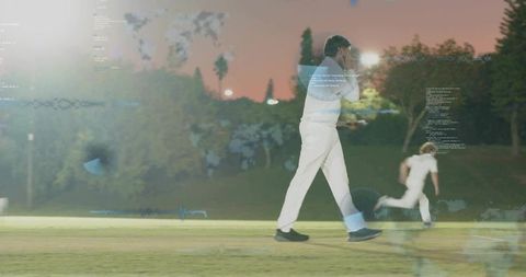 Cricketer walking across twilight field with floodlight telemetry and sports data overlays