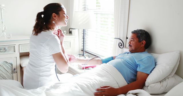 Nurse Checking Blood Pressure of Senior Man in Home Care Setting - Download Free Stock Images Pikwizard.com