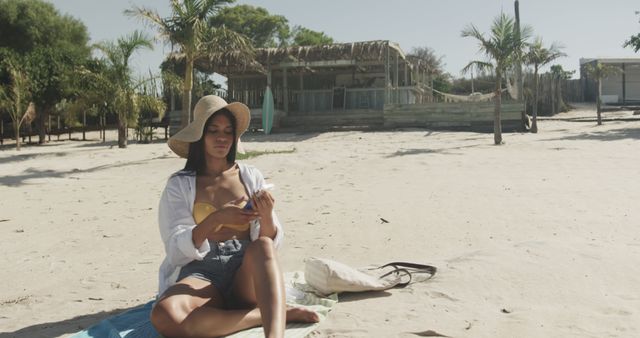 Woman Relaxing on Tropical Beach Applying Sunscreen - Download Free Stock Images Pikwizard.com