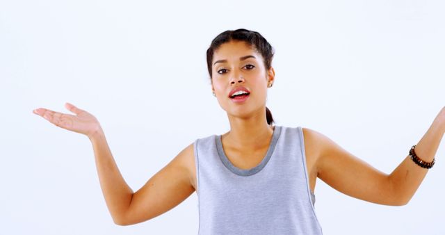 Distracted Woman Shrugging in Casual Gray Tank - Download Free Stock Images Pikwizard.com