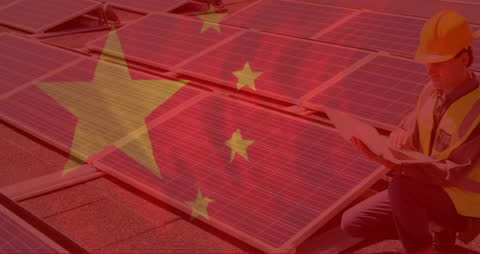 Chinese Flag Overlay with Solar Energy Worker Typing at Computer