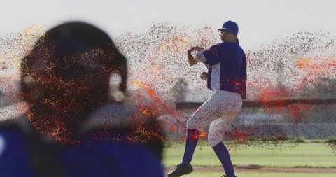 Baseball pitcher preparing throw during game with catcher