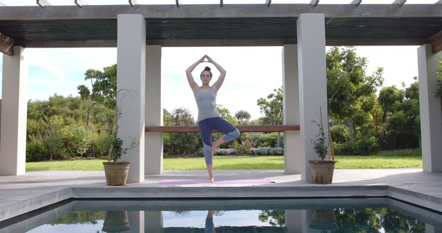 Woman Practicing Yoga Poses by Outdoor Pool on Sunny Day - Download Free Stock Images Pikwizard.com