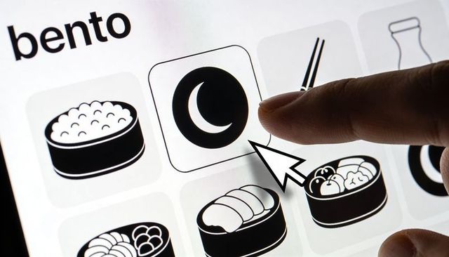 Selecting crescent moon night mode on bento menu ui grid with sushi icons