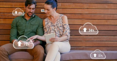 Couple using tablets with data driven cloud technology interface