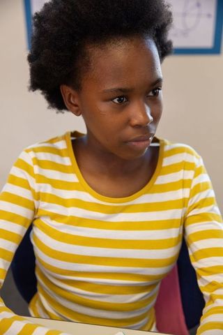 Teenage African American Girl Studying in Classroom