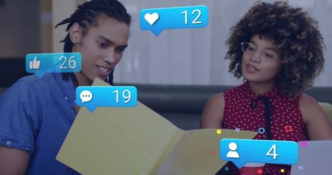 Young professionals reviewing portfolio with social media engagement overlays