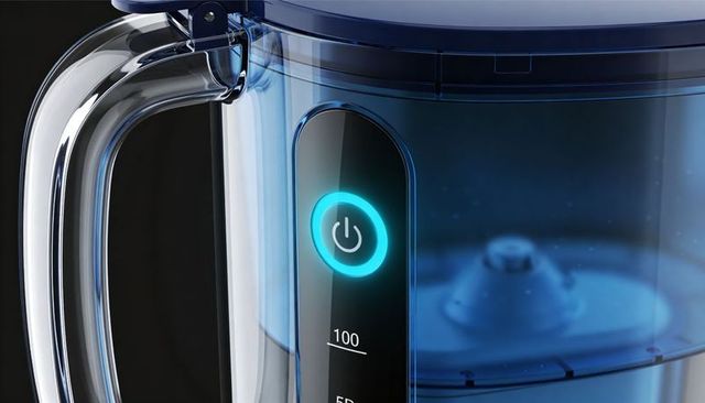 Close-up showing illuminated blue blender pitcher with glowing power button and handle