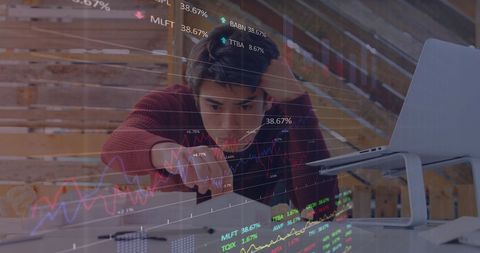 Young Entrepreneur Analyzing Complex Financial Data in Office