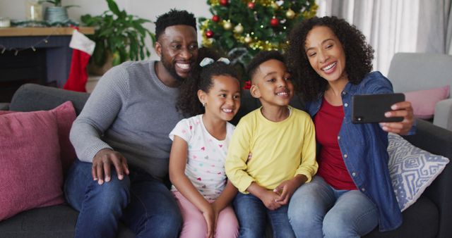 Happy Family Taking Selfie in Living Room During Christmas Celebration - Download Free Stock Images Pikwizard.com