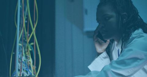 Technician Inspecting Server Rack in Data Center Communication