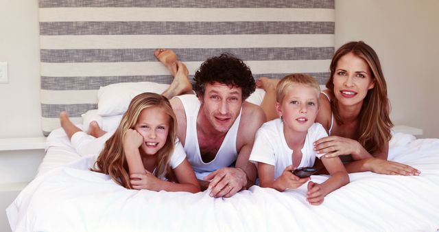 Family Enjoying Time Together on Bed, Smiling and Relaxed - Download Free Stock Images Pikwizard.com