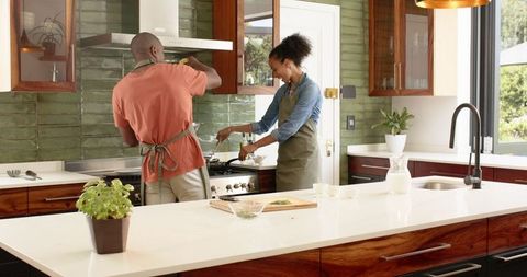 Couple Cooking Together in Contemporary Kitchen Enjoying Culinary Time