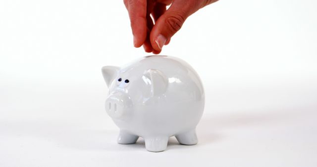 Hand Placing Coin into White Piggy Bank - Download Free Stock Images Pikwizard.com