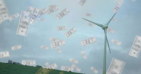 Wind turbine generating money concept showing falling us dollars over green hills