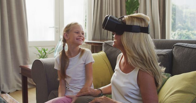 Grandmother Using Virtual Reality with Granddaughter at Home - Download Free Stock Images Pikwizard.com