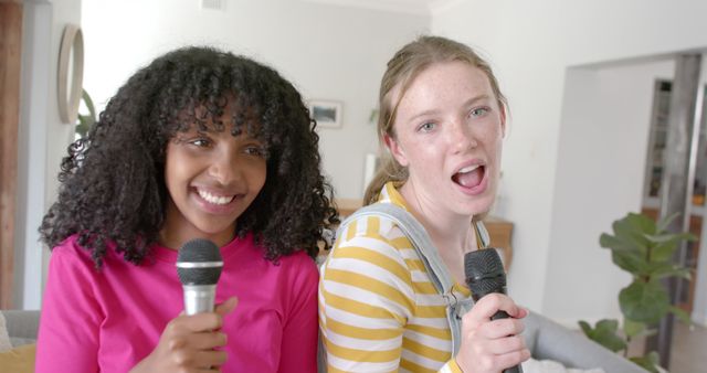 Two Teen Girls Singing Karaoke Together at Home - Download Free Stock Images Pikwizard.com