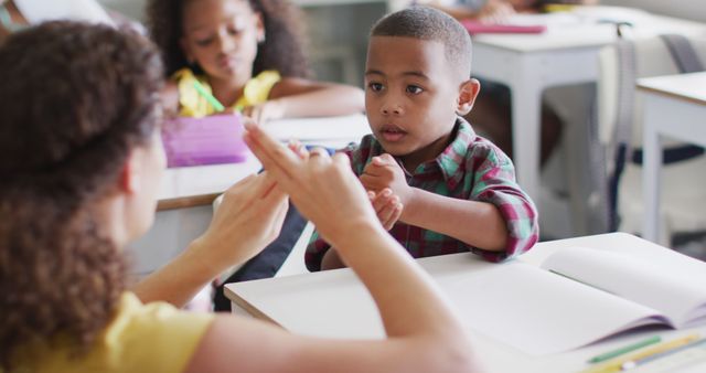 Image of happy caucasian female teacher learning math to african american boy - Download Free Stock Photos Pikwizard.com