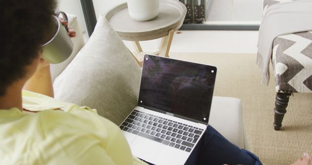 Person Relaxing at Home While Using Laptop and Drinking Coffee - Download Free Stock Images Pikwizard.com