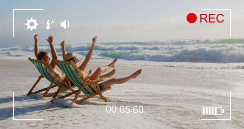 Joyful Caucasian Couple on Beach Vacation in Recording View