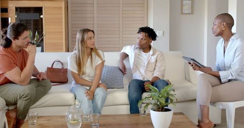 Diverse group brainstorming with african american woman taking notes