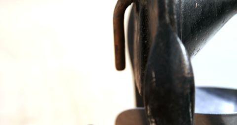 Close-up of black sculpture with textured details and copy space