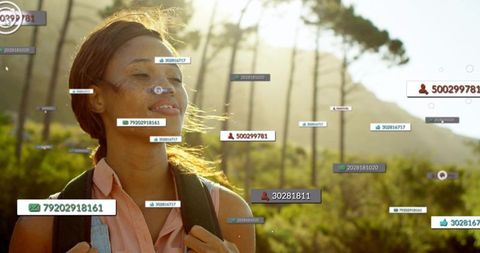 Young woman hiking at golden hour with augmented reality social media labels overlay