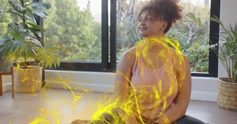 Mindful home yoga with luminous yellow energy particles, wellness meditation and relaxation