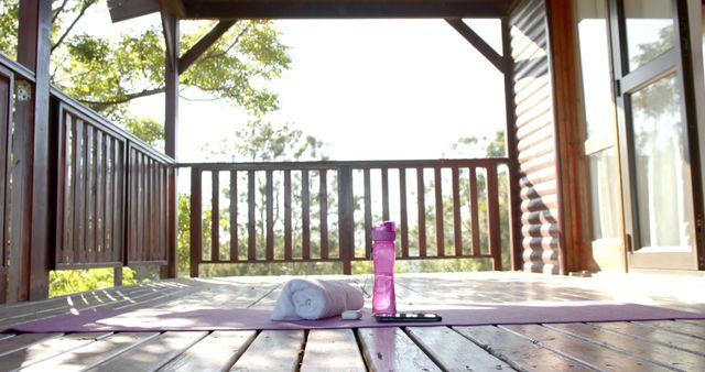 Yoga Mat with Water Bottle and Towel on Wooden Patio - Download Free Stock Images Pikwizard.com