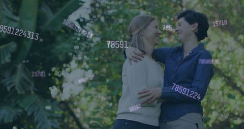 Lesbian couple embracing social media influence outdoors