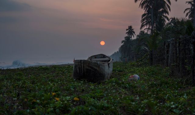 Abandoned Boat on Tropical Beach Under Glowing Sunset - Download Free Stock Photos Pikwizard.com