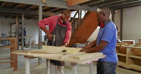 African American Carpentry Team Working In Workshop Woodcraft