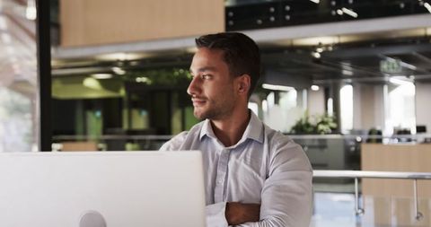 Confident Professional Working in Modern Open-Plan Office