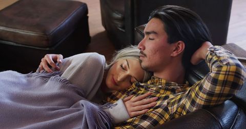 Couple relaxing together on couch in cozy living room