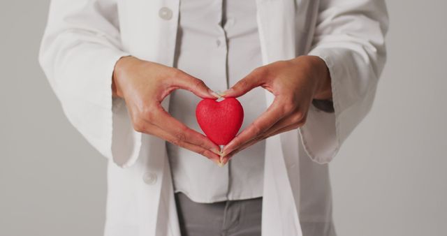 Doctor Holding Heart Shaped Object Symbolizing Healthcare and Compassion - Download Free Stock Images Pikwizard.com