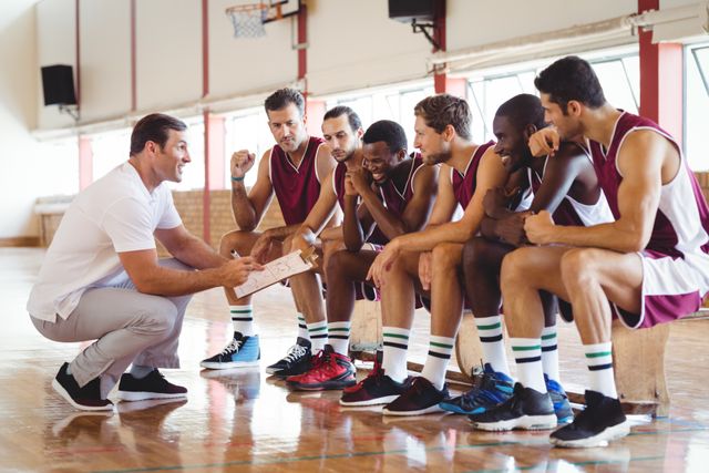 Coach explaining game plan to basketball players in the court