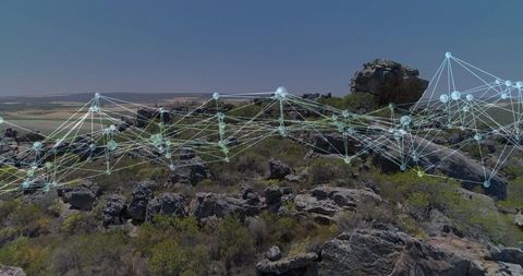 Digital Network Grid Over Rocky Terrain in Natural Landscape