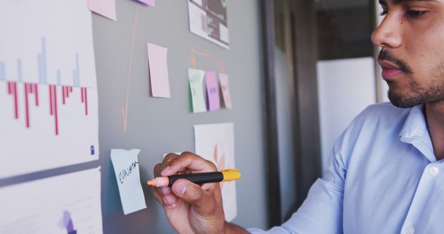 Businessman Planning Strategy with Post-It Notes on Office Wall - Download Free Stock Images Pikwizard.com